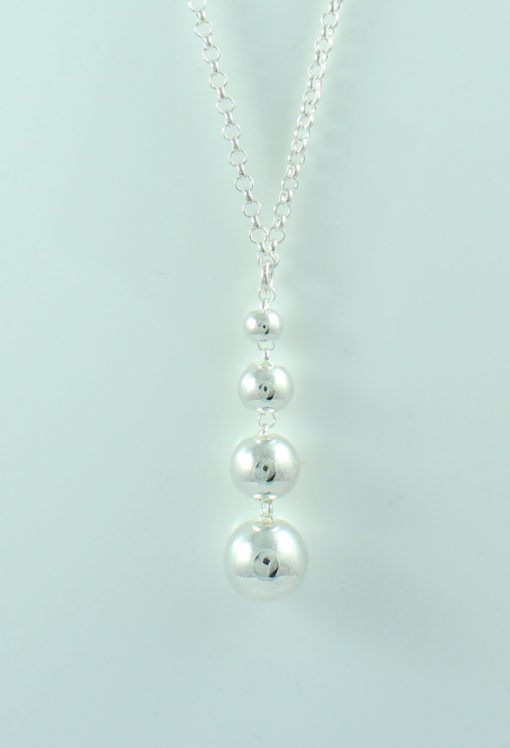 Long Silver Dainty Necklace with 6 Balls Inserted in the Chain with 4 Graduating Ball Pendant